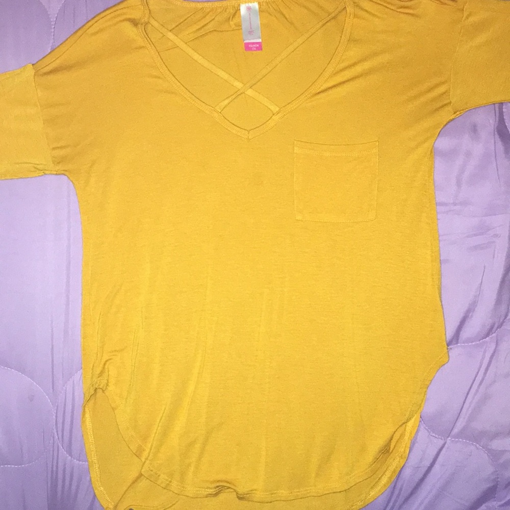 A mustard yellow long sleeve tees shirt